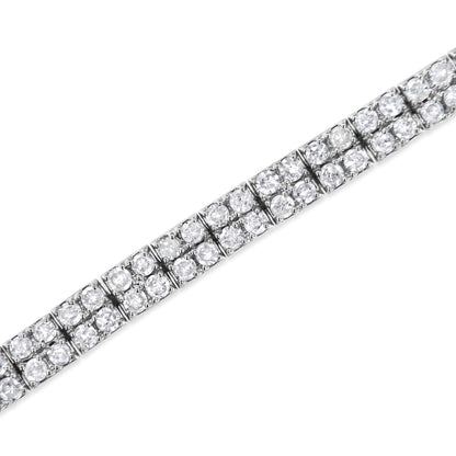 White metal bracelet with multiple rows of round white gemstones in prong settings, shown in a close-up angled view.