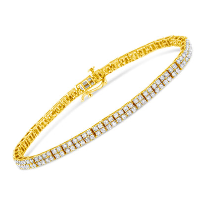 Yellow metal bracelet with rows of round white gemstones in prong setting, shown in angled close-up.