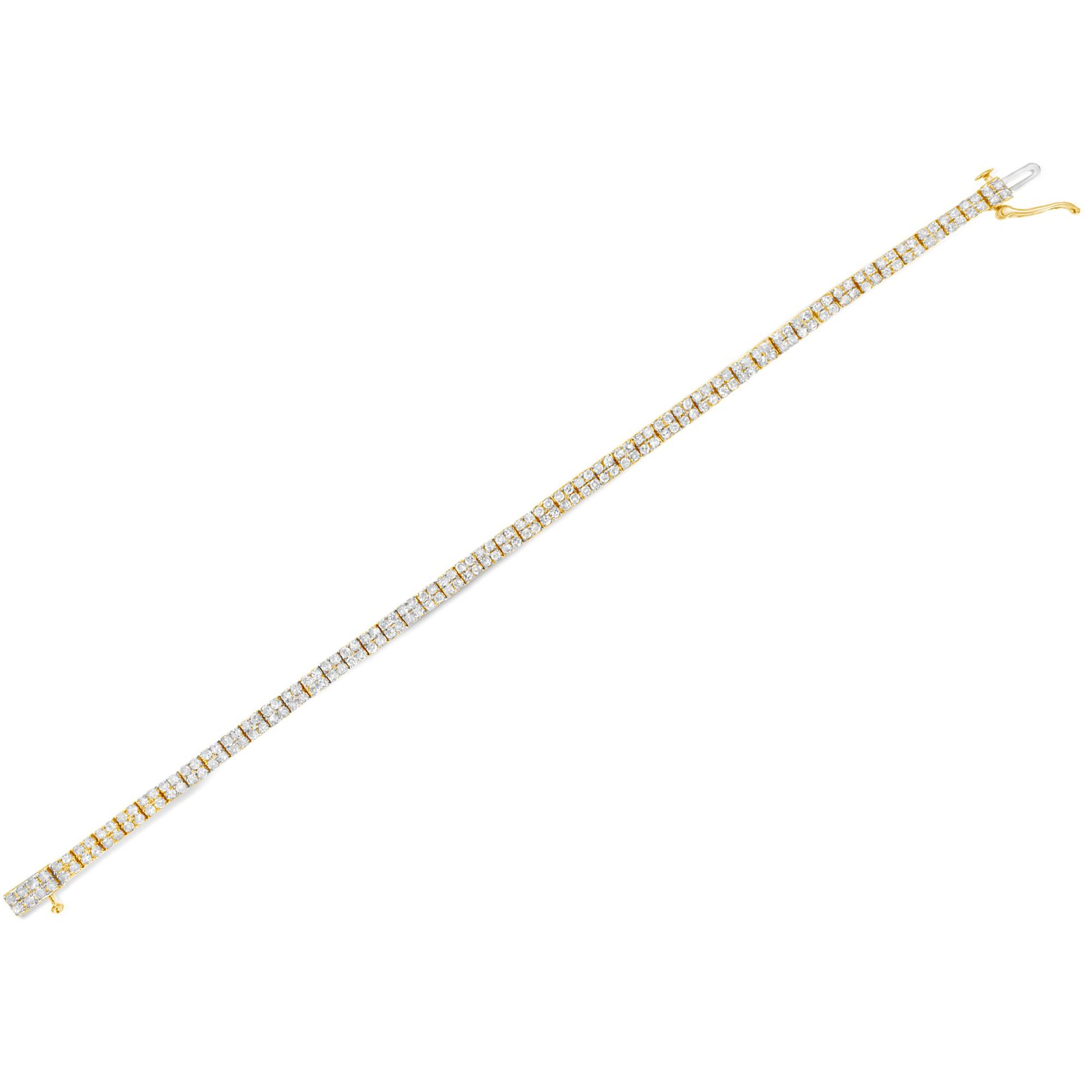 Diagonal top-down view of a yellow metal bracelet featuring a continuous row of prong-set white round gemstones.