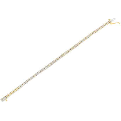 Diagonal top-down view of a yellow metal bracelet featuring a continuous row of prong-set white round gemstones.