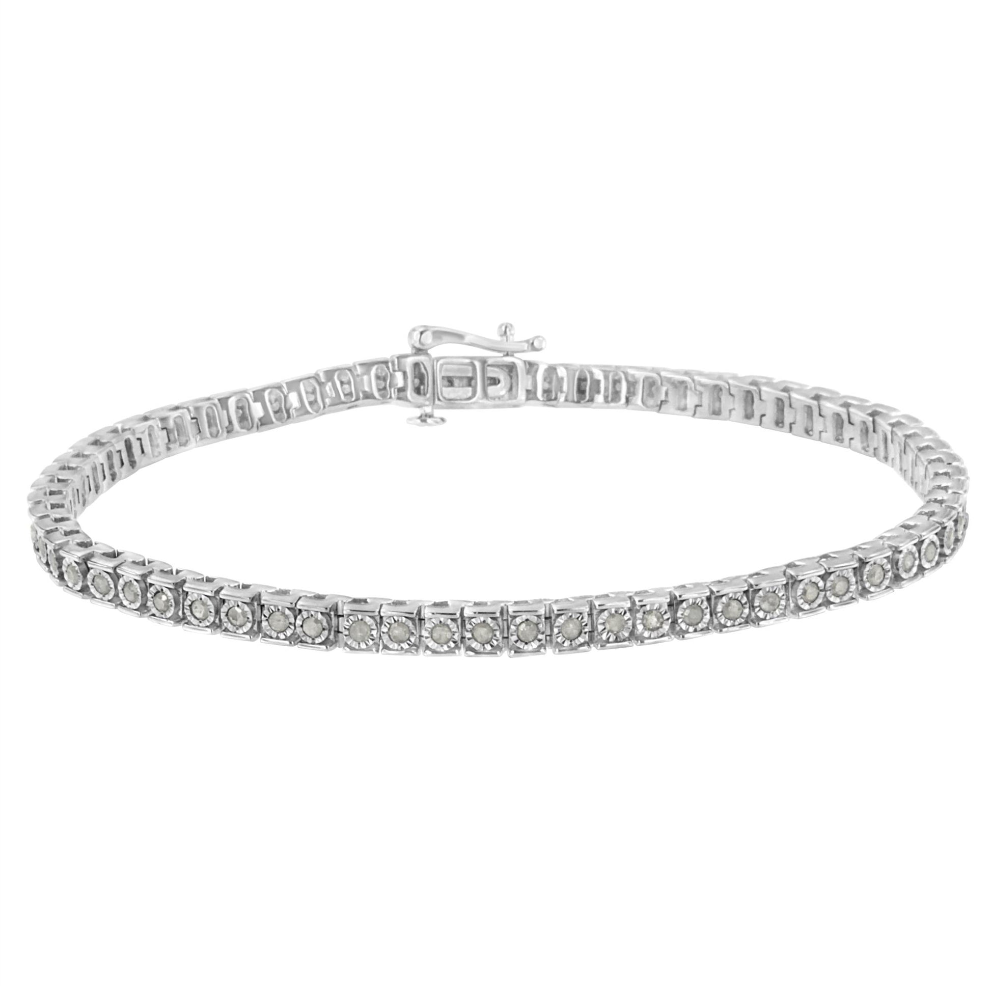 White metal bracelet with round white gemstones in a channel setting, shown from a front angled view.