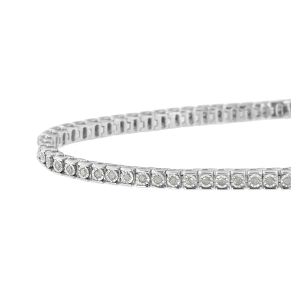 Close-up angled view of a white metal bracelet with round white gemstones in a channel setting.