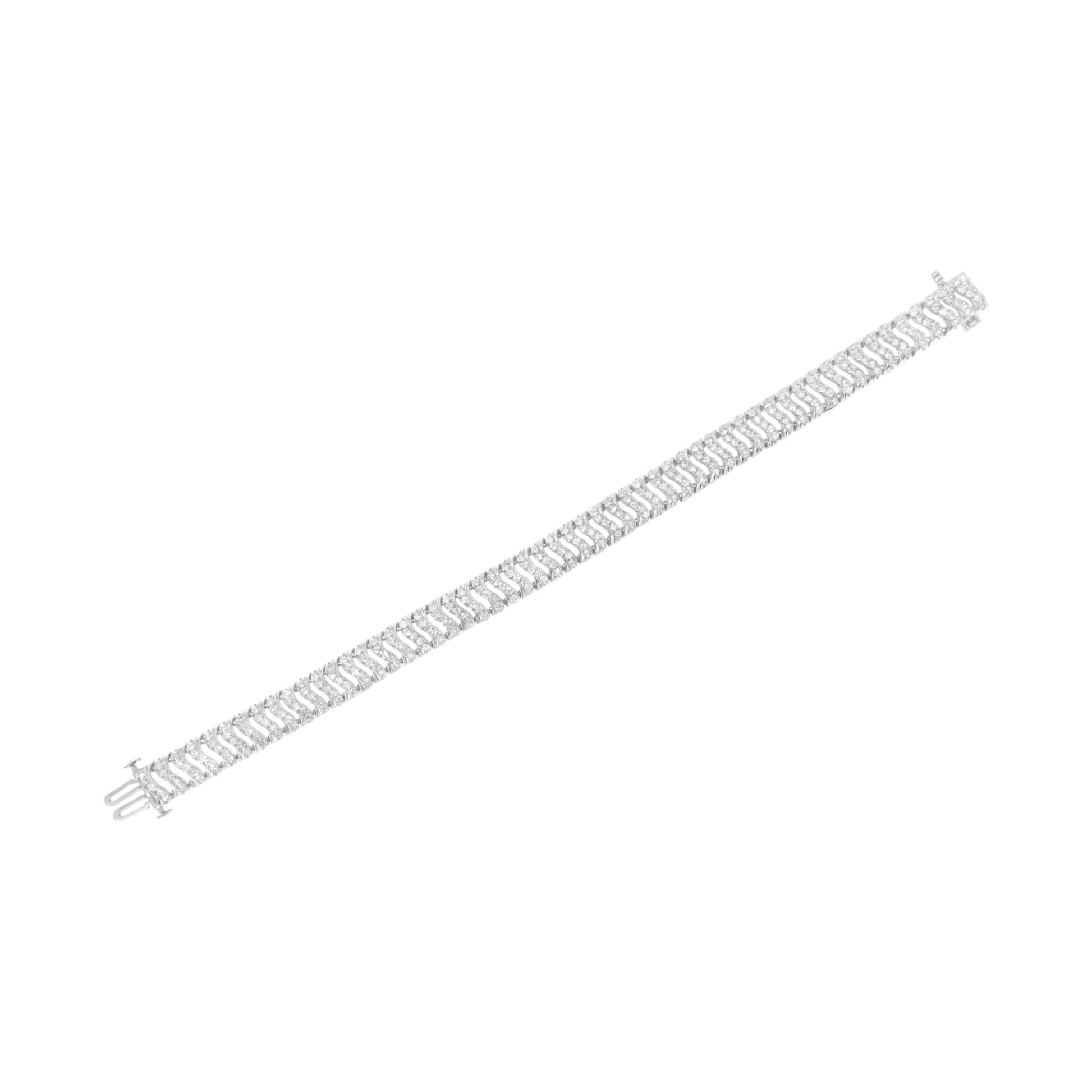 White metal bracelet with multiple rows of round white gemstones in prong settings, shown flat from a top-down angle.