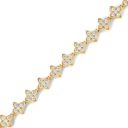 Diagonal close-up of a yellow bracelet featuring floral-shaped links adorned with white round gemstones in prong settings.