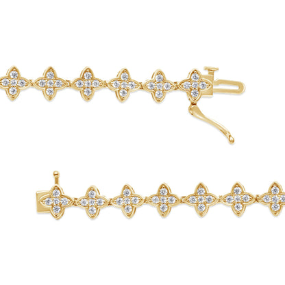 Top angle view of yellow metal bracelet with multiple four-petal flower-shaped links each set with white round gemstones in prong settings.