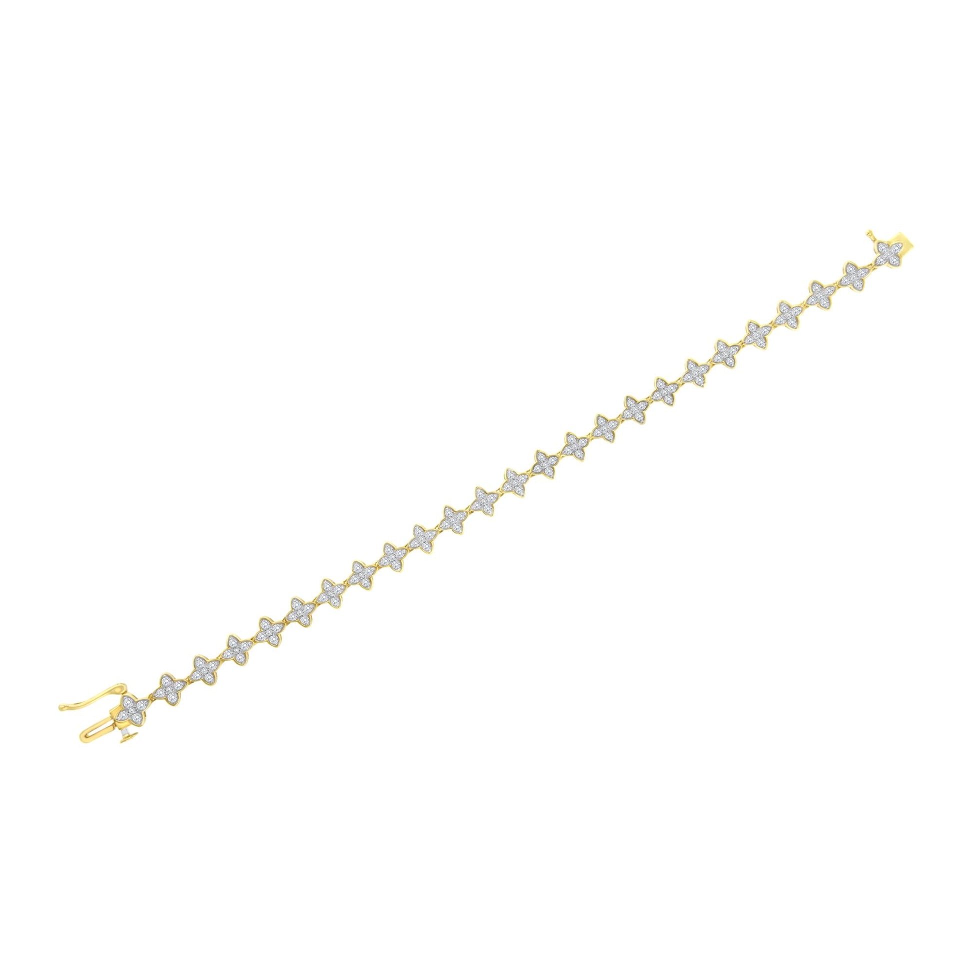 Yellow metal bracelet with a row of flower-shaped links, each set with white round gemstones, shown from a top oblique angle.