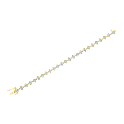 Yellow metal bracelet with a row of flower-shaped links, each set with white round gemstones, shown from a top oblique angle.