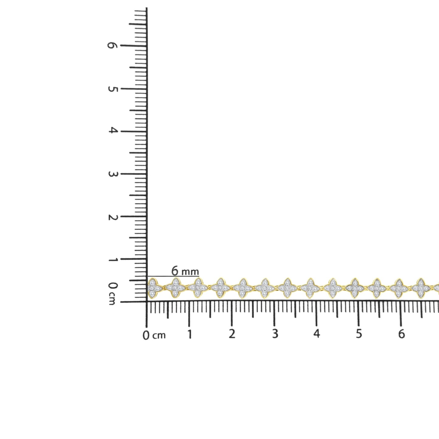 Yellow bracelet with white round gemstones in prong settings, laid flat next to a ruler for size reference, shot from above.