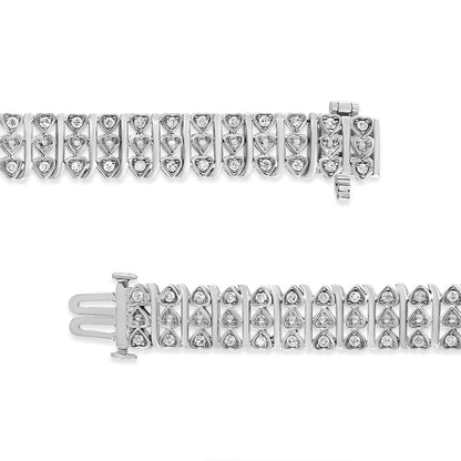 Top-down view of a white metal bracelet with heart-shaped links, each containing round white gemstones in prong settings, shown partially unclasped.