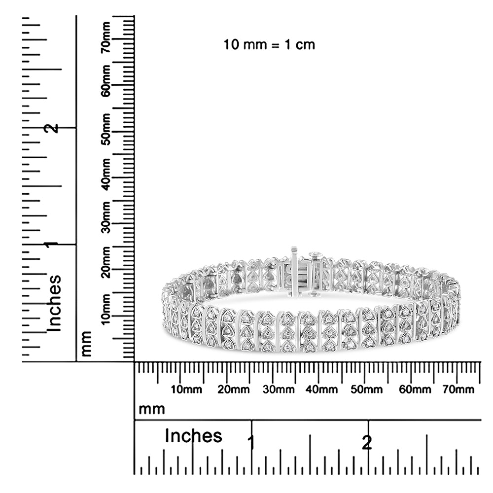 White metal bracelet with round white gemstones in prong settings, displayed on a ruler for size reference, front angle view.