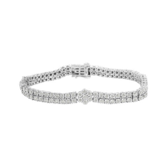 White metal bracelet with two rows of round white gemstones in miracle setting and a floral cluster centerpiece, front angle.