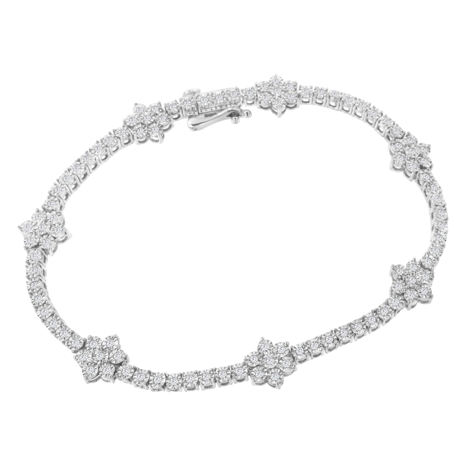 Top angled close-up of a white metal bracelet featuring round white gemstones in a miracle setting, arranged with floral clusters along the band.