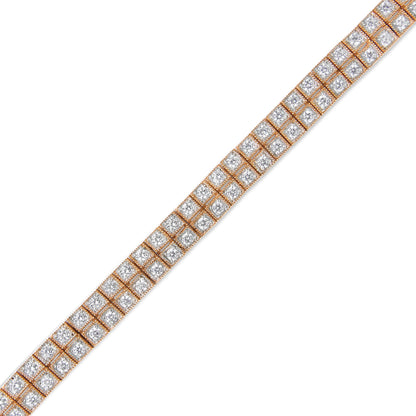 Diagonal close-up view of a rose-colored metal bracelet with two rows of round white gemstones set in prong settings.
