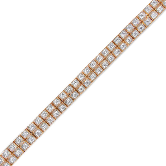 Diagonal close-up view of a rose-colored metal bracelet with two rows of round white gemstones set in prong settings.