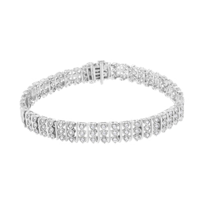 White metal bracelet with multiple round white gemstones in prong settings, shown from a top angled view.