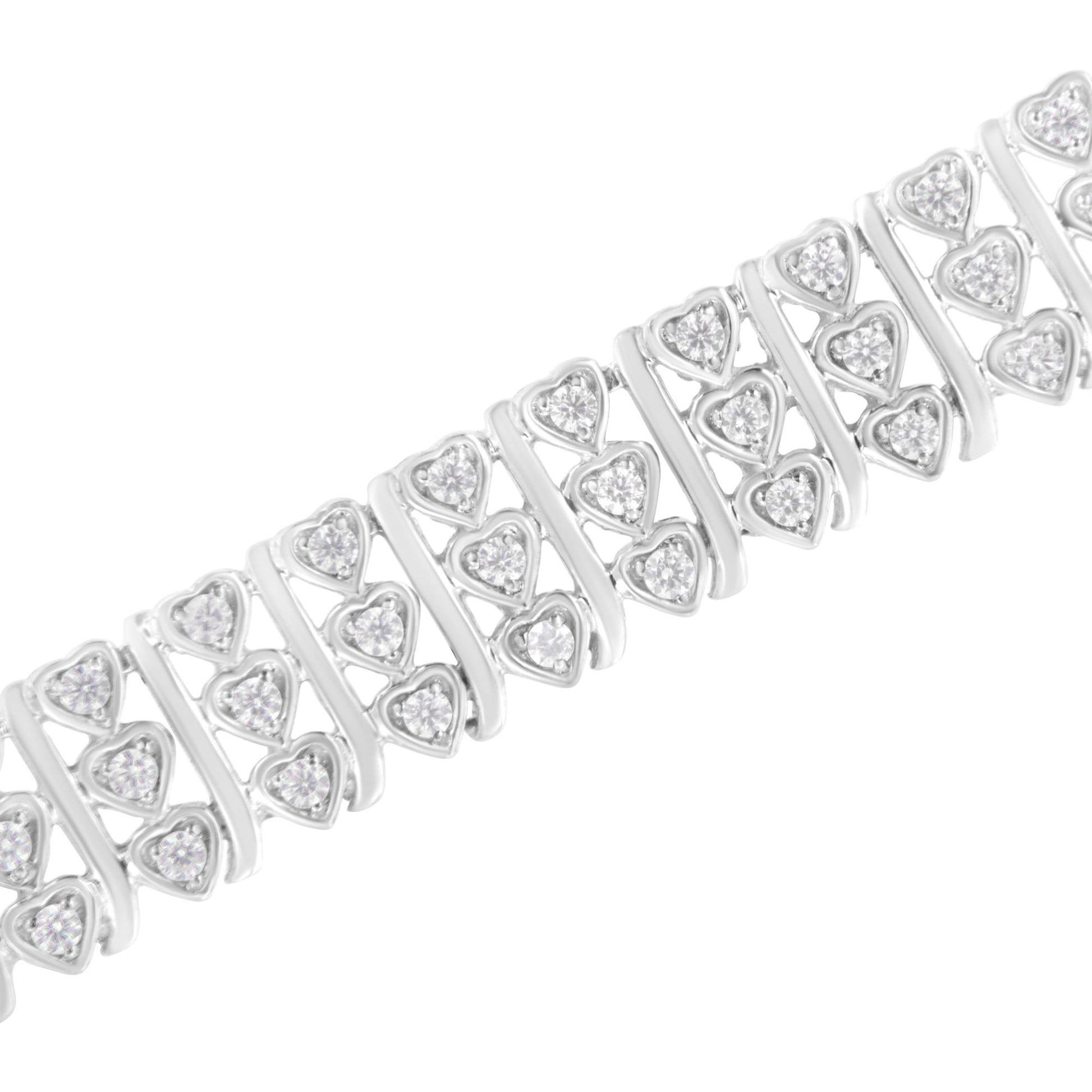 Close-up angled view of a white metal bracelet featuring multiple rows of heart-shaped links, each set with round white gemstones in prong settings.