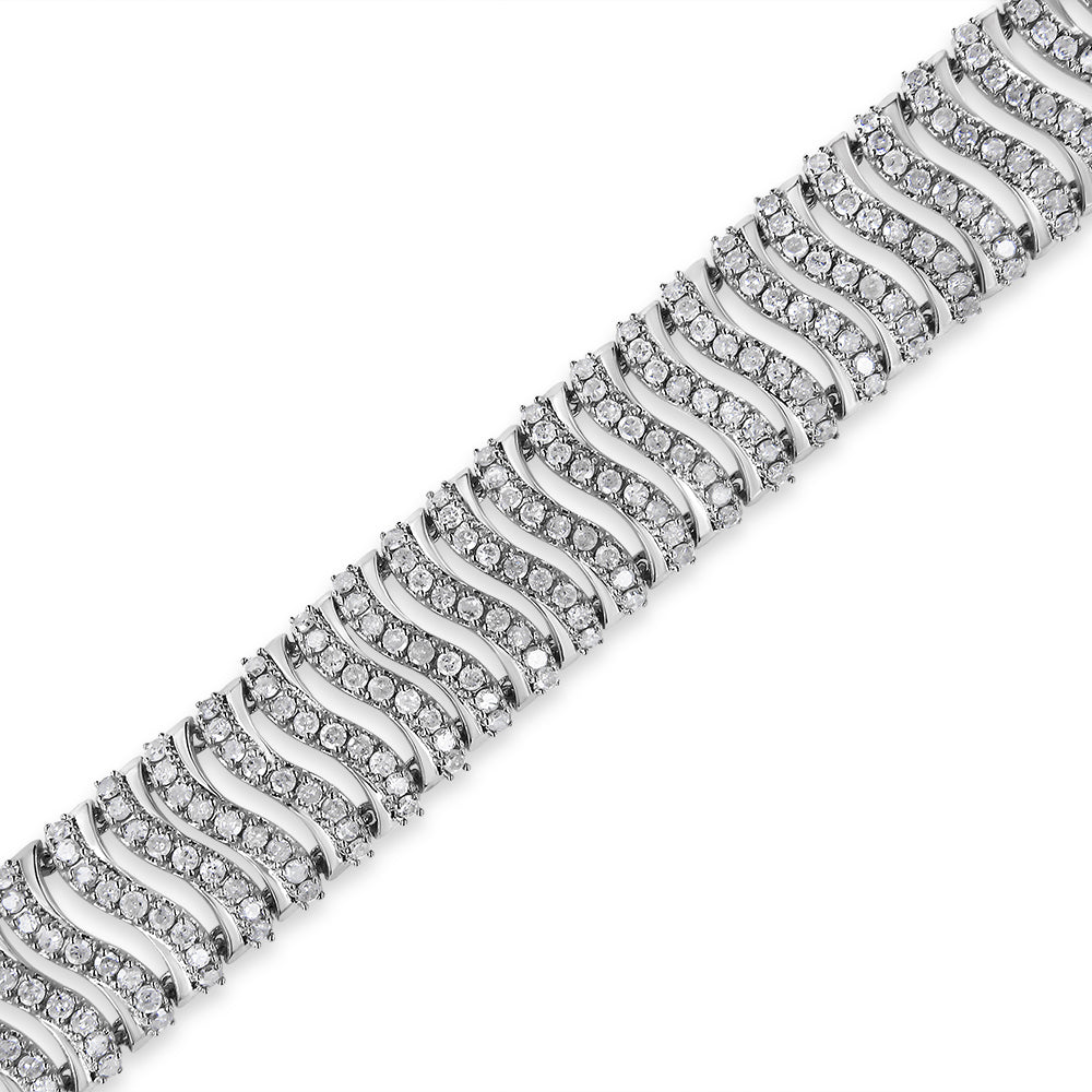 Close-up angled view of a white metal bracelet with wavy pattern links, each set with multiple round white gemstones in prong settings.
