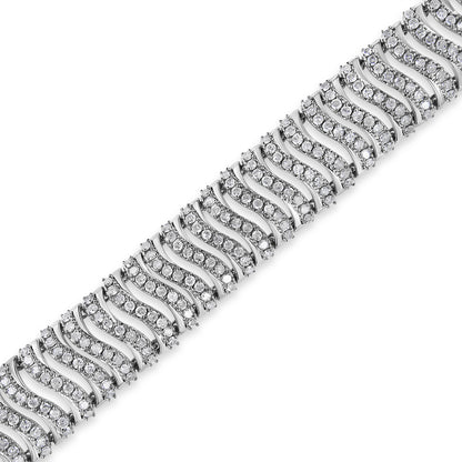 Close-up angled view of a white metal bracelet with wavy pattern links, each set with multiple round white gemstones in prong settings.