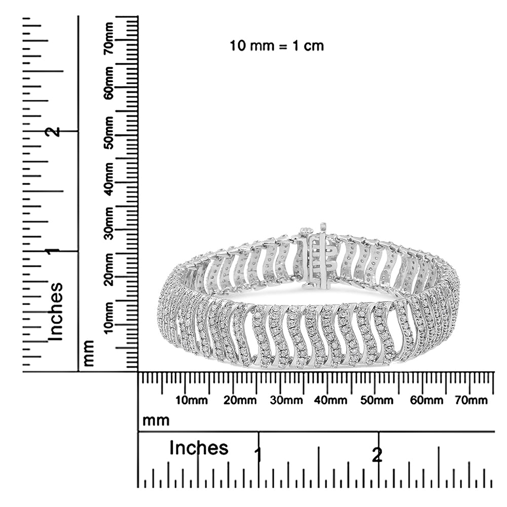 White metal bracelet with wavy design featuring round white gemstones in prong settings, shown on a ruler for size reference from front angle.