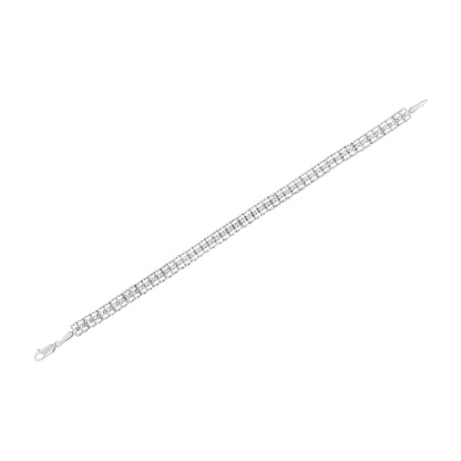 White metal bracelet with round white gemstones in prong settings, shown flat from a top angle.