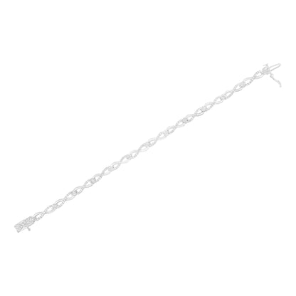 White metal bracelet with intertwined oval links featuring small round white gemstones in prong settings, shown in a top-down angle.