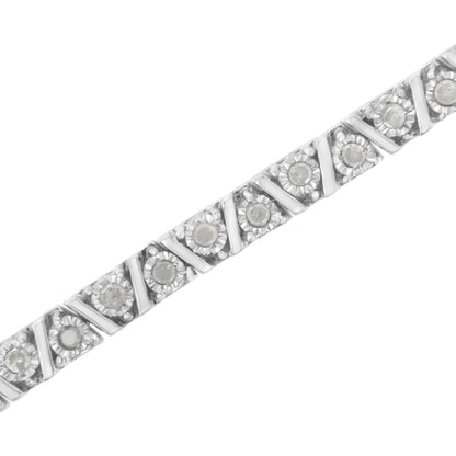 Diagonal close-up of a white metal bracelet with round white gemstones in a miracle setting.