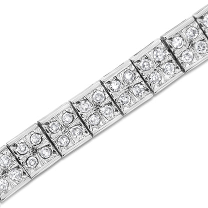 Close-up angled view of a white metal bracelet with square links, each set with multiple round white gemstones in prong settings.