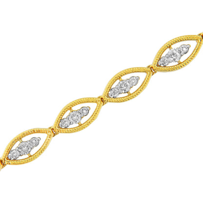 Yellow metal bracelet with marquise-shaped links featuring clusters of round white gemstones in prong settings, shown at a diagonal angle.