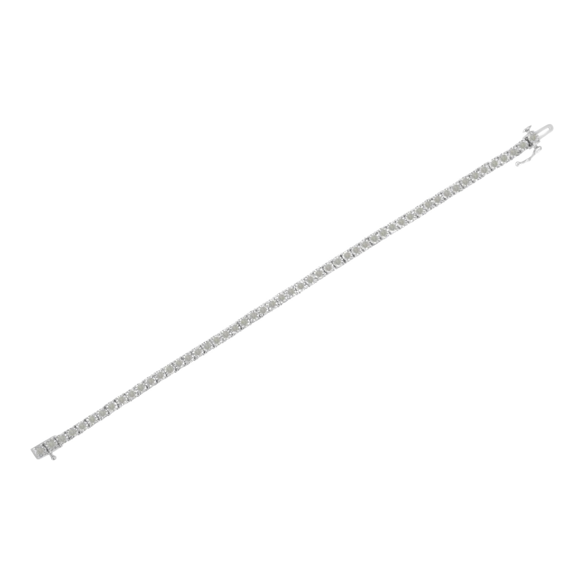 White metal bracelet with round white gemstones in a miracle setting, shown in a flat lay angled top-down view.