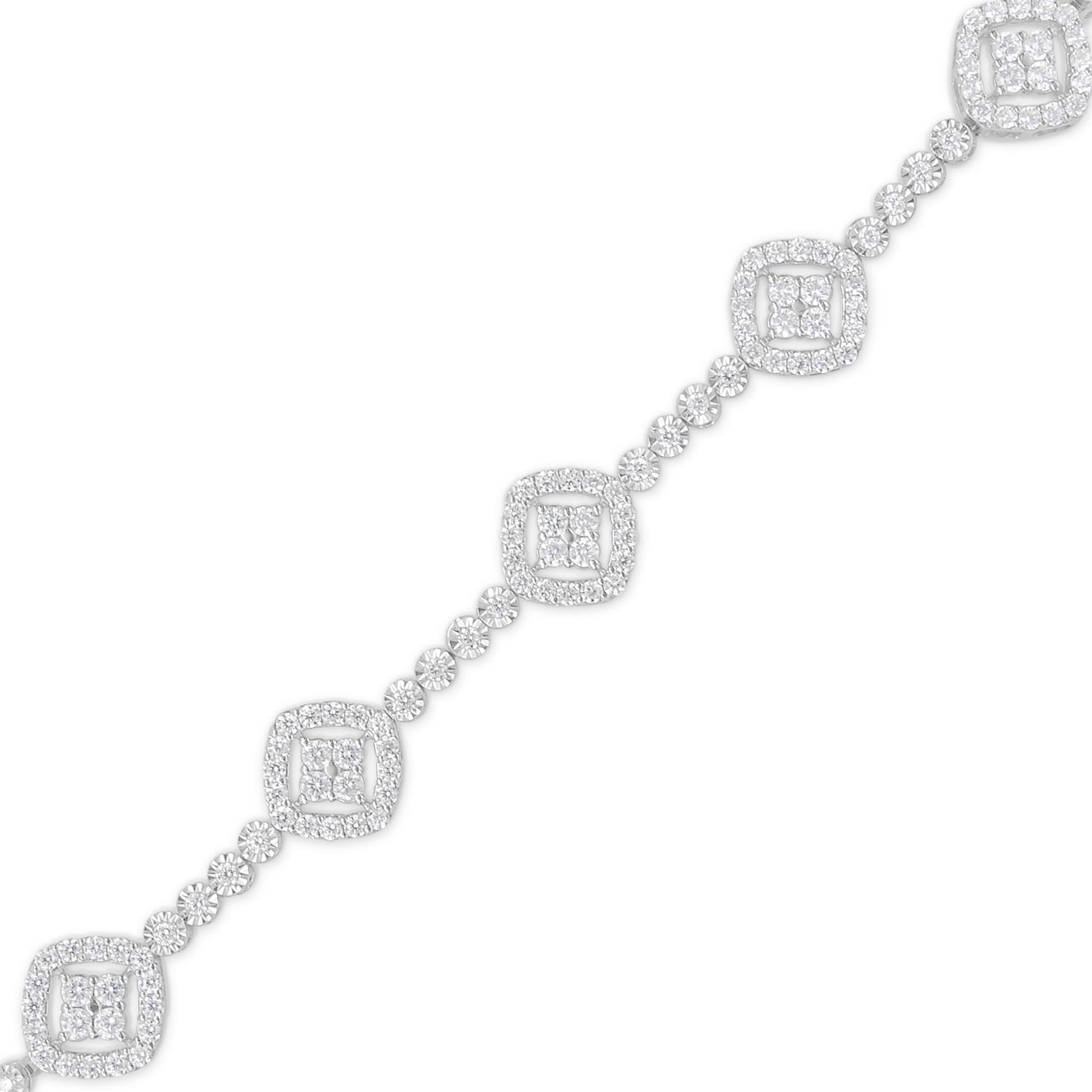 Diagonal shot of a white metal bracelet featuring alternating square and round clusters of white gemstones, with round gemstones connecting the squares, viewed against a white background.