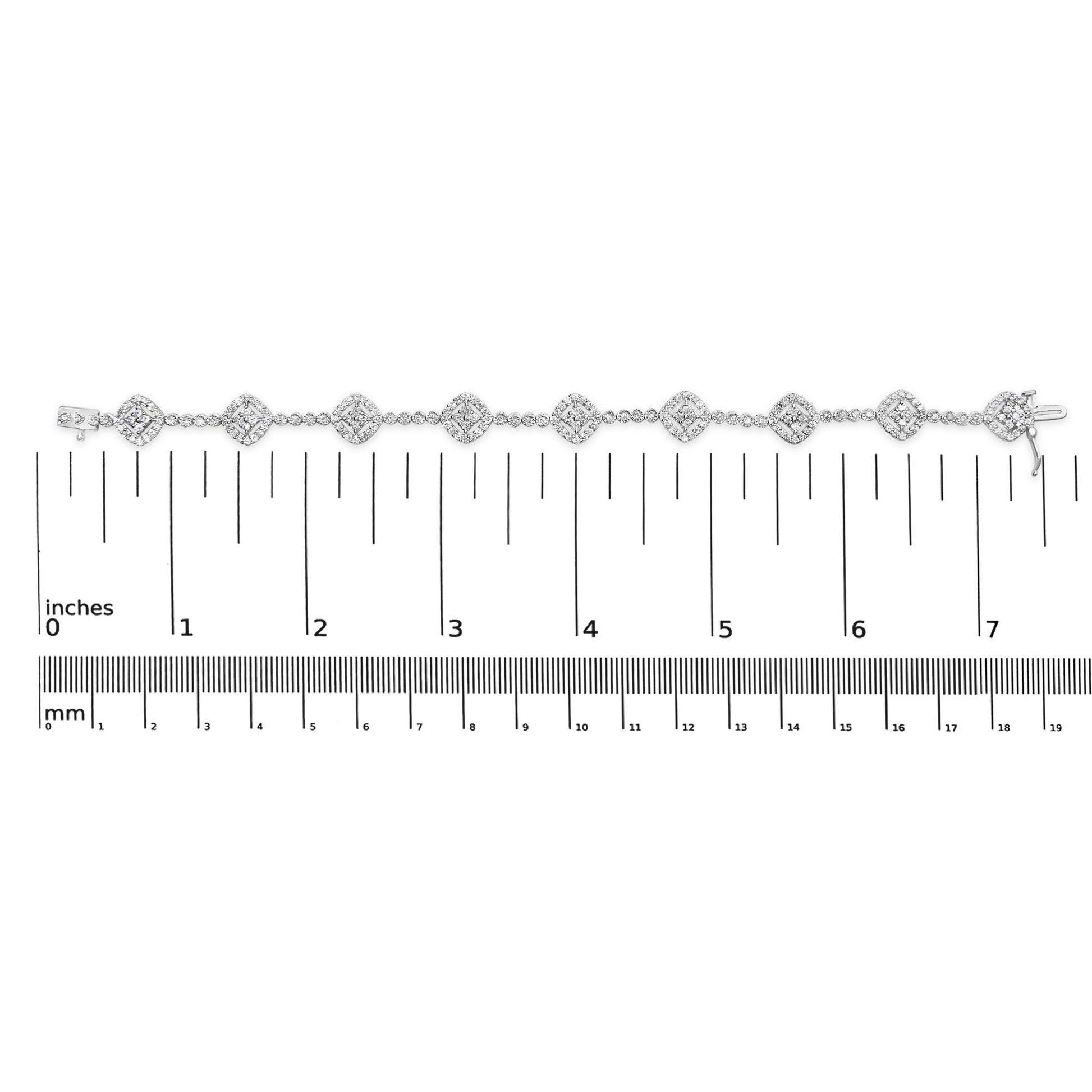 White metal bracelet with round white gemstones in miracle and prong settings, displayed flat on a ruler for size reference, top-down view.
