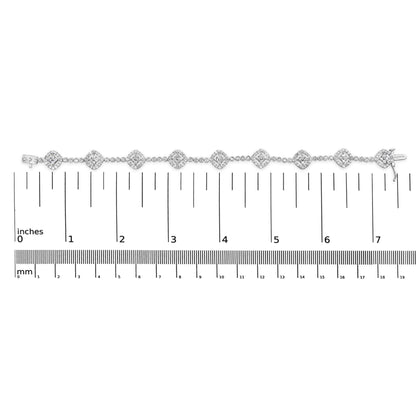 White metal bracelet with round white gemstones in miracle and prong settings, displayed flat on a ruler for size reference, top-down view.