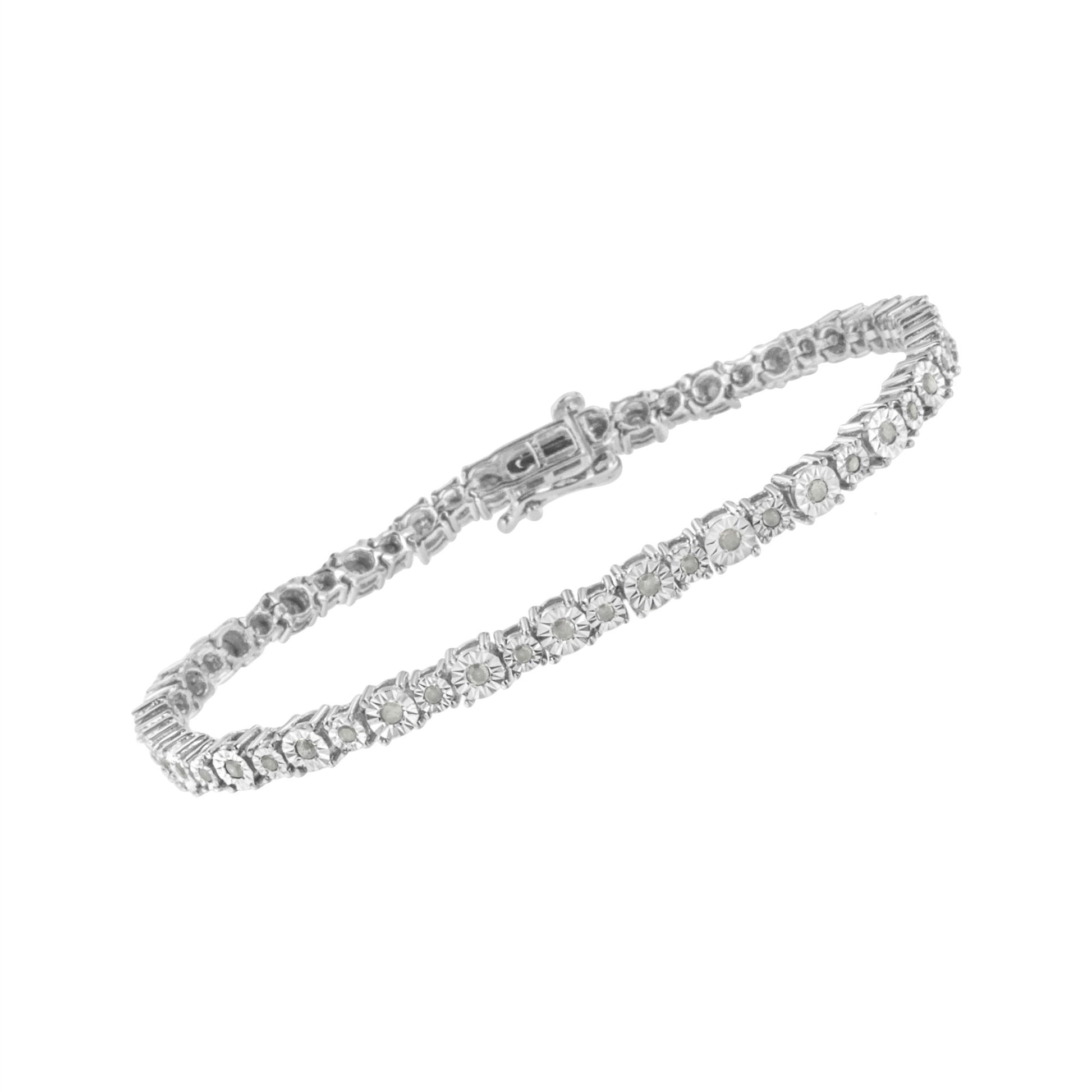 White metal bracelet with round white gemstones in a miracle setting, shown at a slight angle on a white background.