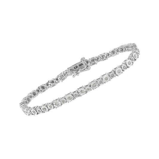 White metal bracelet with round white gemstones in a miracle setting, shown at a slight angle on a white background.