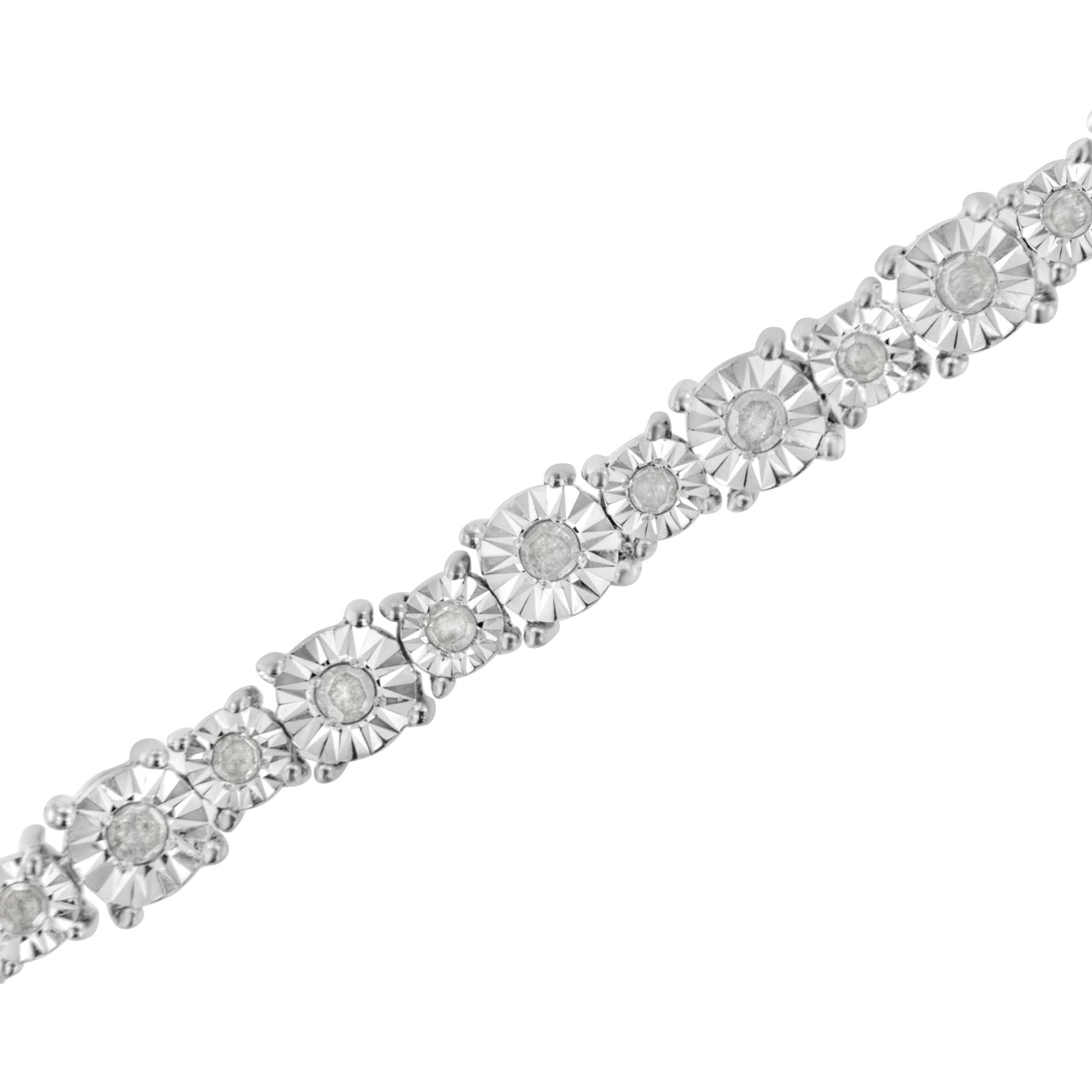 Close-up angled view of a white metal bracelet featuring round white gemstones set in a miracle setting.