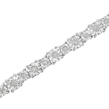 Close-up angled view of a white metal bracelet featuring round white gemstones set in a miracle setting.