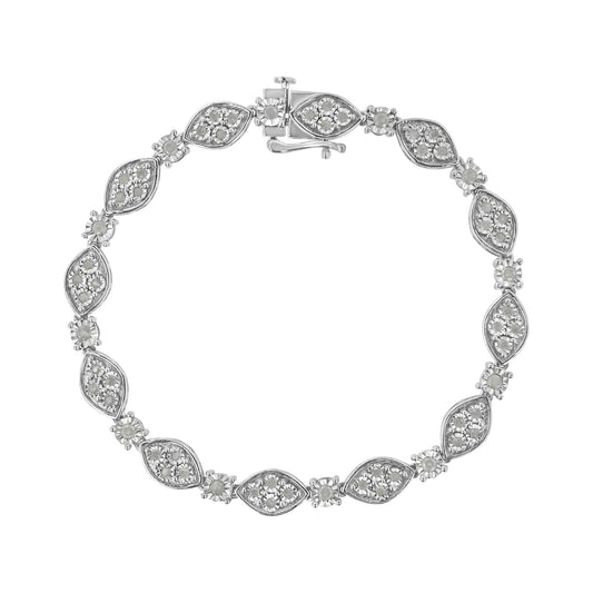 Top-down view of a white metal bracelet with alternating marquise-shaped and round settings, each containing multiple white gemstones in a miracle setting.