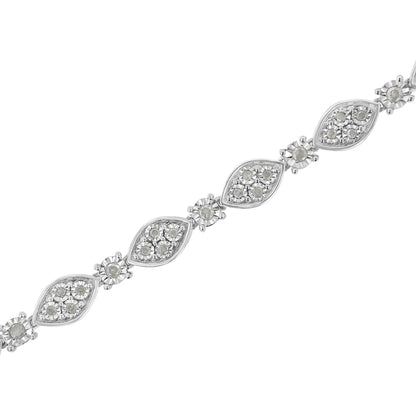 Diagonal close-up of white metal bracelet featuring marquise-shaped links set with clusters of round white gemstones in miracle setting.