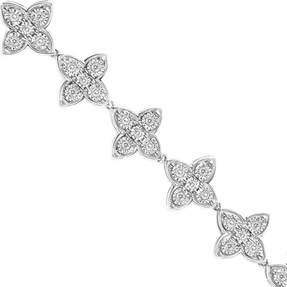 Close-up angled view of a white metal bracelet featuring linked floral-shaped sections adorned with round white gemstones in a miracle setting.