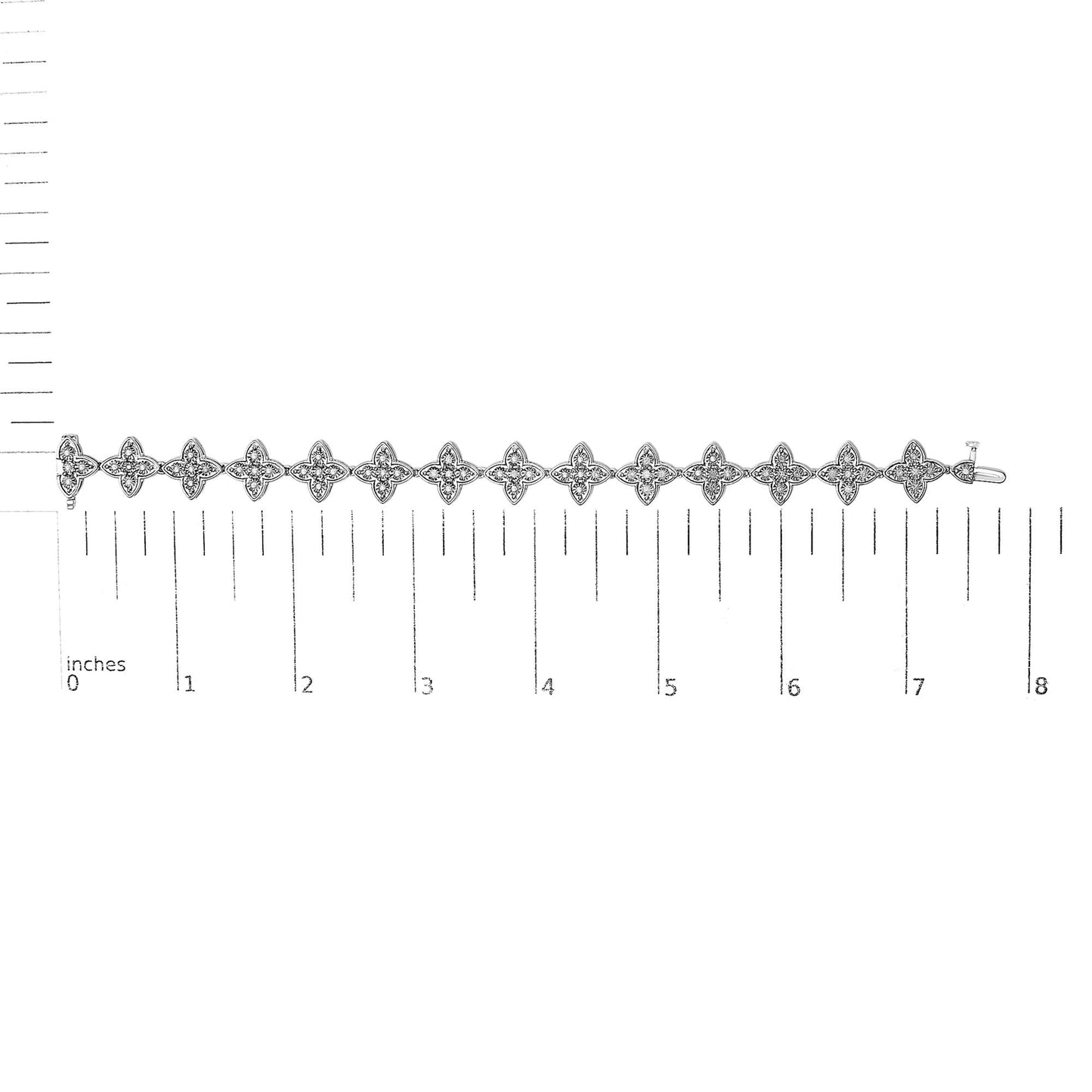 White metal bracelet with floral-shaped links each set with white round gemstones, shown from top angle on a ruler for size reference.