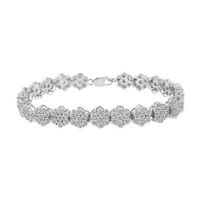 White metal bracelet with flower-shaped links each set with round white gemstones, shown from a front angle.