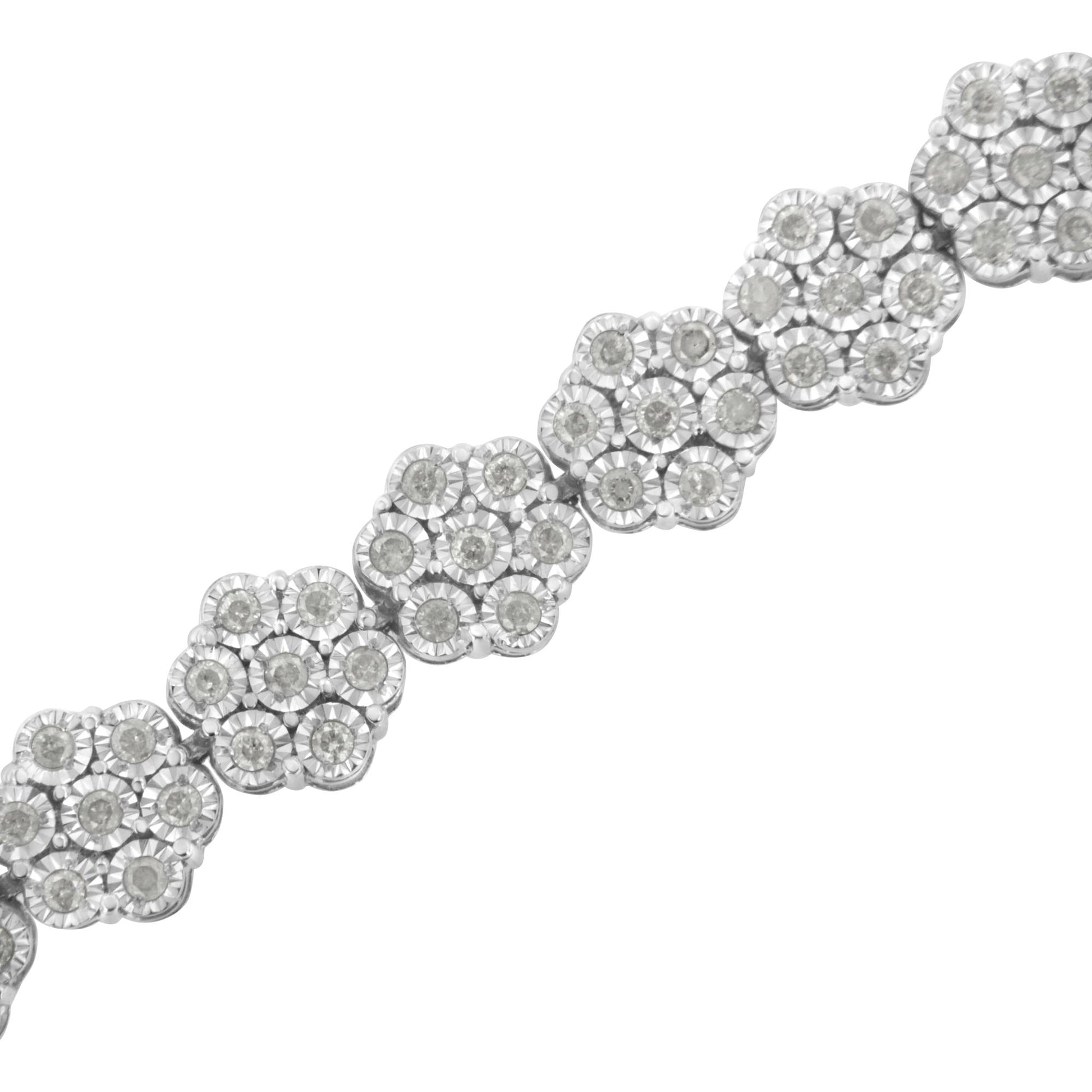 Diagonal close-up of a white metal bracelet featuring linked floral clusters with round white gemstones in a miracle setting.