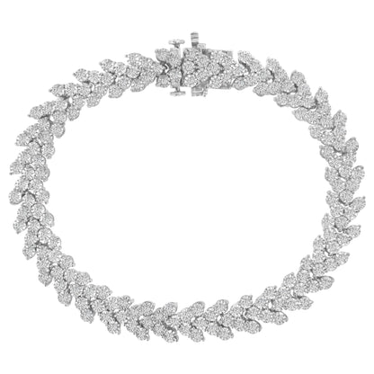 Top-down view of a white metal bracelet with round white gemstones in a Miracle setting forming a floral pattern.