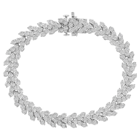 Top-down view of a white metal bracelet with round white gemstones in a Miracle setting forming a floral pattern.