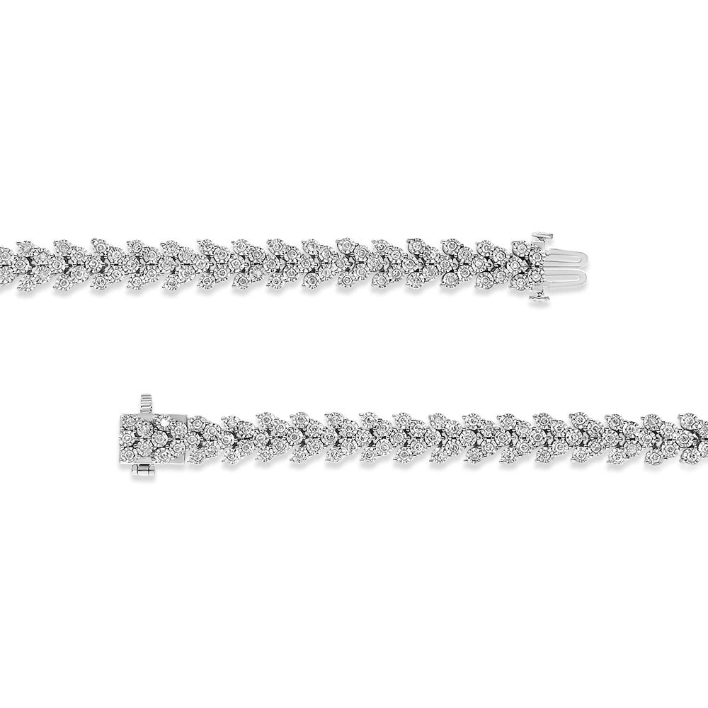 Top-down view of two white metal bracelets featuring a leaf-like pattern with round white gemstones in a miracle setting, shown side by side with clasps visible.
