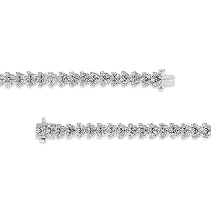 Top-down view of two white metal bracelets featuring a leaf-like pattern with round white gemstones in a miracle setting, shown side by side with clasps visible.