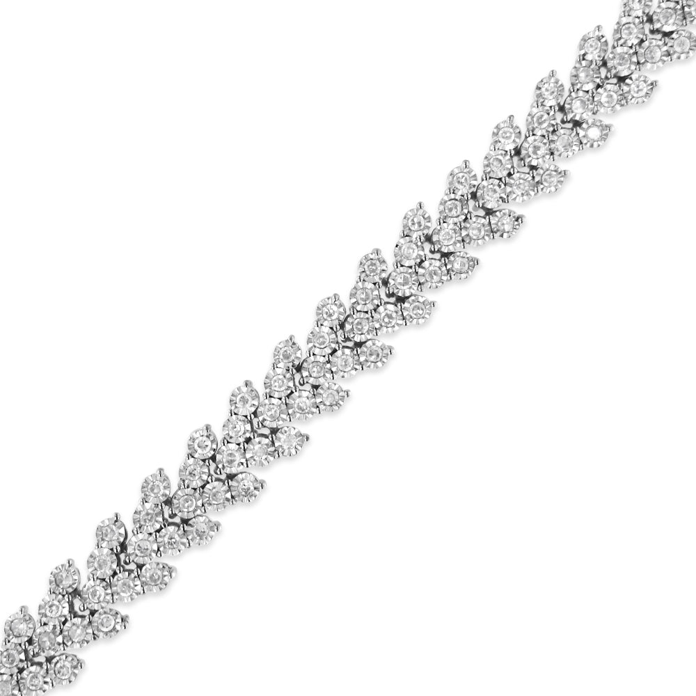 Close-up diagonal view of a white metal bracelet with round white gemstones in a miracle setting.