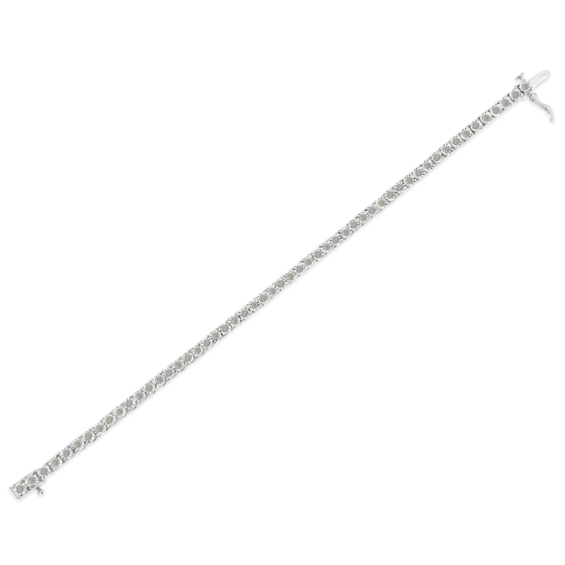 White metal bracelet with round white gemstones in a line with miracle setting, shown flat from an angled top view.