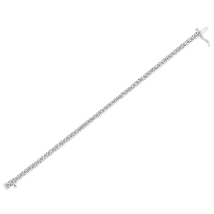 White metal bracelet with round white gemstones in a line with miracle setting, shown flat from an angled top view.