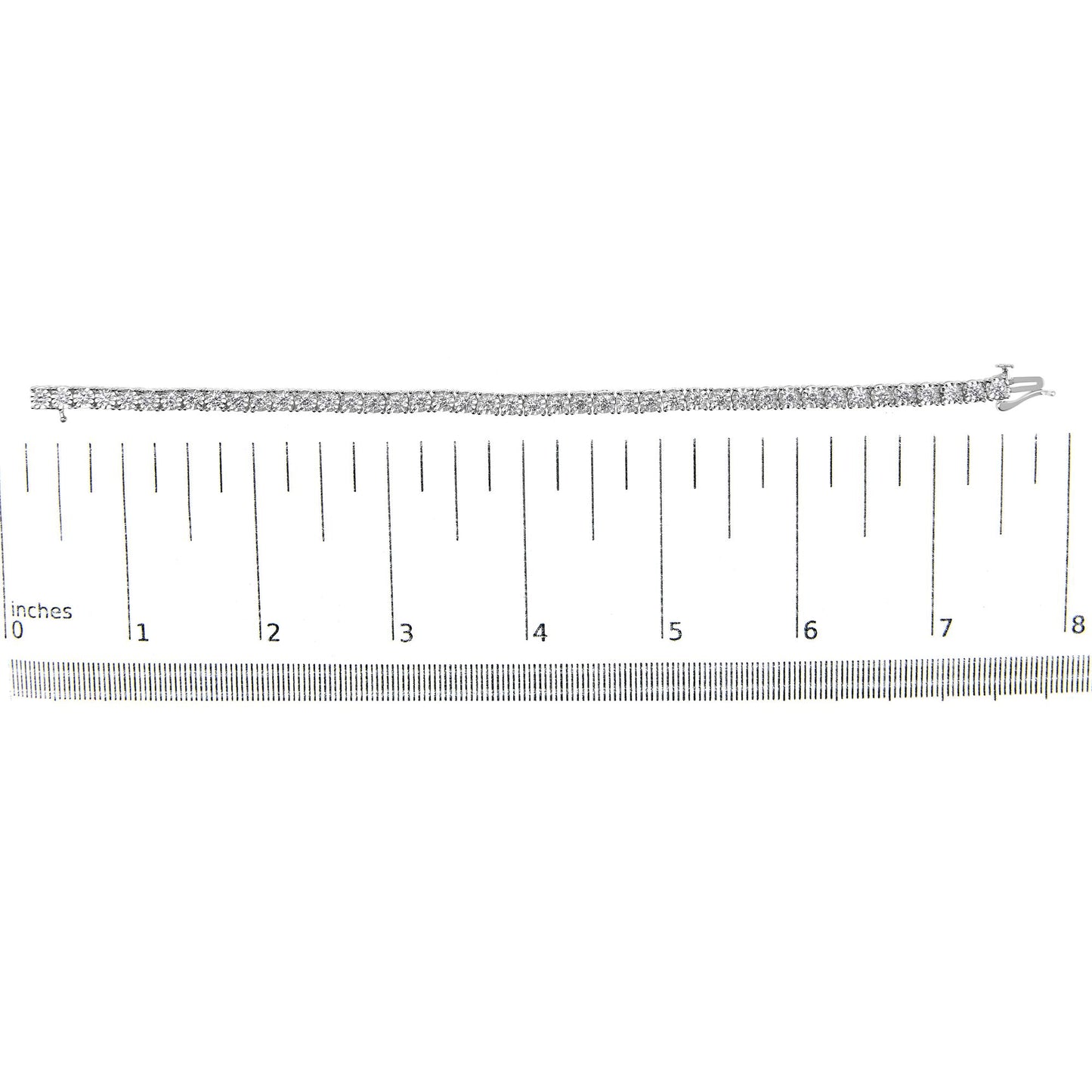 White metal bracelet with round white gemstones in miracle setting, displayed flat on a ruler for size reference, top-down angle.
